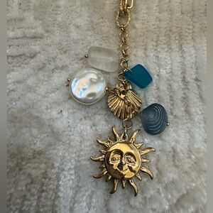 Gold Sun Charm Necklace with Blue & Pearl Accents